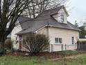 Rear view of home with light colored siding, brown roof and partially fenced in yard at 658 Chestnut St, Noblesville, IN 46060