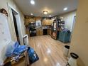 Spacious kitchen with hardwood flooring, black appliances, and ample cabinetry at 658 Chestnut St, Noblesville, IN 46060