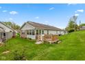 Back exterior showing patio with well-maintained lawn at 6640 S New Jersey St, Indianapolis, IN 46227