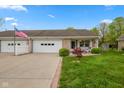 Inviting ranch style home with brick accents, an attached garage and meticulously kept front lawn at 6640 S New Jersey St, Indianapolis, IN 46227