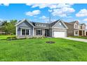 Charming single-Gathering home featuring stone accents and a two-car garage at 7136 Jackson Dr, Cumberland, IN 46229