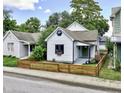 Street view of a charming home with a fresh exterior, complemented by mature trees and a well-maintained front yard at 722 E Minnesota St, Indianapolis, IN 46203