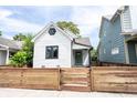 A charming white home with a green door and freshly stained wooden fence at 722 E Minnesota St, Indianapolis, IN 46203