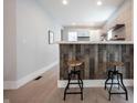 Interior featuring a stylish kitchen bar with wooden stools, complemented by modern countertops and stainless steel appliances at 722 E Minnesota St, Indianapolis, IN 46203