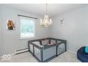 Bright bedroom with a chandelier, and a cozy play area for children at 7546 Lindenwood Dr, Indianapolis, IN 46227