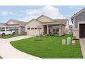 Attractive one-story home with lush green lawn and a cozy front porch seating area, perfect for enjoying the outdoors at 796 Sapp Cir, Westfield, IN 46074