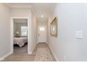 Bright hallway with wood floors and a view into the bedroom, offering a welcoming and open transition at 796 Sapp Cir, Westfield, IN 46074