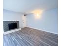 Living room boasts a fireplace with decorative tile and gray wood laminate flooring at 8350 Paso Del Norte Ct, Indianapolis, IN 46227