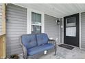 Inviting covered porch featuring a comfortable bench, ideal for relaxing outdoors at 842 Miller Ave, Shelbyville, IN 46176