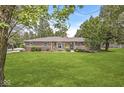 Charming single-story brick home with a well-manicured lawn, mature trees, and inviting curb appeal at 8814 E 146Th St, Noblesville, IN 46060