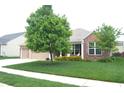 Beautiful single Gathering house showcasing lovely landscaping, brick accents, and a charming front porch area at 8855 Banner Dr, Brownsburg, IN 46112
