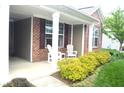 Cozy front porch with comfortable seating, stylish shutters, and meticulously maintained landscaping at 8855 Banner Dr, Brownsburg, IN 46112
