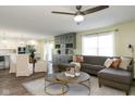 Open-concept living room with neutral decor, modern furnishings, hardwood floors, and seamless kitchen access at 996 Denton Ct, Westfield, IN 46074
