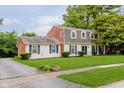 Classic two-story home showcasing a brick and siding exterior, complemented by a lush green lawn at 1101 High Ct, Carmel, IN 46033