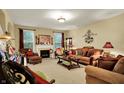 Inviting living room featuring a fireplace, sofas, neutral colored walls, and a piano at 1141 Lazio Ct, Greenwood, IN 46143