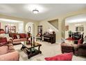 Spacious living room featuring sofas, a piano, and staircase leading to upper level at 1141 Lazio Ct, Greenwood, IN 46143