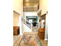 Grand foyer with soaring ceilings, wrought iron staircase, and wood floors at 13766 Heatherfield Dr, Fishers, IN 46038