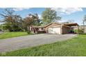 A well-maintained single-Gathering home with an attached garage and carport on a green lawn at 1416 Wellington Ave, Indianapolis, IN 46219