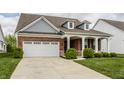 Beautiful single-Gathering home featuring a brick facade, a two-car garage, and a well-maintained yard at 14878 Anees Ln, Fishers, IN 46040