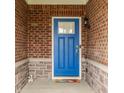 Inviting entryway with a bright blue door, brick surround, and a decorative welcome mat at 14878 Anees Ln, Fishers, IN 46040