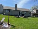 Spacious backyard includes a well-maintained lawn and planting beds along the rear of the house at 1502 Austin Dr, Lebanon, IN 46052
