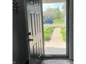View of the front yard through an open front door and screen at 1502 Austin Dr, Lebanon, IN 46052