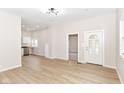 Bright, neutral living space with wood floors, white trim, and an open floor plan connecting to the kitchen at 1523 S K St, Elwood, IN 46036
