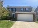 Charming two-story home featuring a well-maintained lawn, attached two car garage and black shutter accents at 15406 Destination Dr, Noblesville, IN 46060