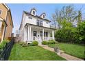 Inviting white two-story home features a classic design and well-maintained landscaping at 2044 Alvord St, Indianapolis, IN 46202