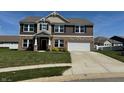Attractive two-story home featuring a brick and siding exterior, complete with a two-car garage at 2068 Deer Valley Ct, Columbus, IN 47201