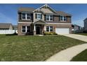 Beautiful home with a well-manicured lawn, complemented by a brick and vinyl siding exterior at 2068 Deer Valley Ct, Columbus, IN 47201