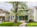 Inviting two-story home featuring a spacious front porch and mature trees at 328 N Layman Ave, Indianapolis, IN 46219
