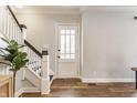 Bright foyer with staircase, hardwood floors, and natural light at 328 N Layman Ave, Indianapolis, IN 46219