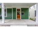 Inviting front porch with wooden door, overhead lighting, and attractive house number at 328 N Layman Ave, Indianapolis, IN 46219