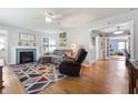 Inviting living room with a cozy fireplace, comfortable seating, and warm hardwood floors at 335 N Franklin Rd, Indianapolis, IN 46219
