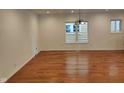 Bright living room featuring gleaming hardwood floors and natural light from windows at 3629 Birchwood Ave, Indianapolis, IN 46205