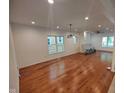 Spacious living room with recessed lighting, hardwood floors, and large windows at 3629 Birchwood Ave, Indianapolis, IN 46205