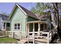 Side view of a charming green home with a well-maintained yard and an accessible ramp at 474 N Randolph St, Indianapolis, IN 46201