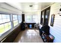 Enclosed porch with tile flooring, bright windows, and a welcoming atmosphere at 480 E Walnut St, Martinsville, IN 46151