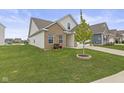 This home boasts beautiful landscaping and a view of the neighborhood pond at 5423 Maywood Dr, Whitestown, IN 46075