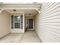 Covered front porch featuring a dark brown front door, shuttered window and siding at 5864 Mustang Ter, Plainfield, IN 46168
