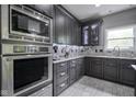 Well-equipped kitchen with stainless steel oven, microwave, and granite countertops at 5925 Silas Moffitt Way, Carmel, IN 46033