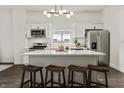 Open concept kitchen with an island featuring barstool seating, stainless appliances, and modern lighting at 629 N Keystone Ave, Indianapolis, IN 46201