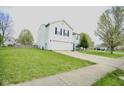 Well-maintained home with a spacious lawn, two-car garage, and inviting curb appeal at 6634 Frankenberger Dr, Indianapolis, IN 46237