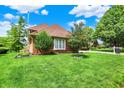 Well-maintained brick home on a lush green lawn with mature landscaping at 676 La Placita St, Greenwood, IN 46143