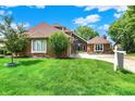 Beautiful brick house with mature tree and a lush green lawn at 676 La Placita St, Greenwood, IN 46143