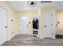 Inviting foyer with coat rack and shoe storage, seamlessly blending style and functionality with attractive vinyl flooring at 6842 Viola Ct, Indianapolis, IN 46237