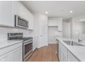 Bright kitchen features white cabinets, stainless steel appliances, and quartz countertops at 6871 Seabiscuit Rd, Whitestown, IN 46075