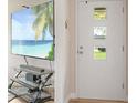 View of front door with decorative windows with a TV featuring a beach scene in the background at 70 Casco Dr, Avon, IN 46123