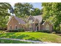 Beautiful brick home featuring a well-maintained lawn and lush landscaping for great curb appeal at 7126 Nile Ridge Ct, Indianapolis, IN 46236